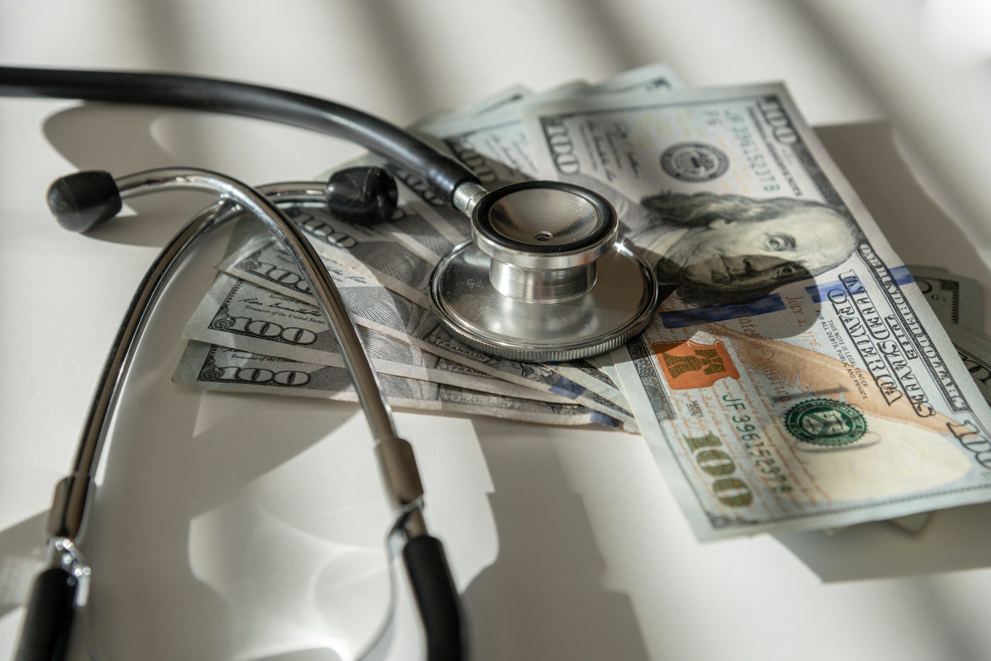 Money on a table with a Stethoscope showing how much Medicare Part B cost.