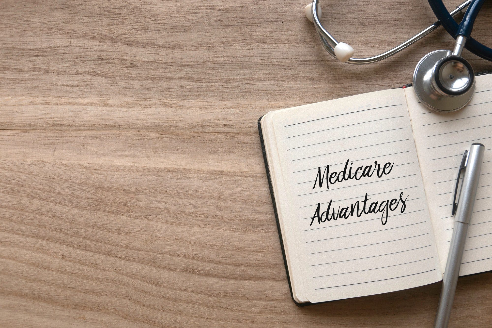 The wording Medicare Advantages wrote out on a notebook referring to an HMO Plans.
