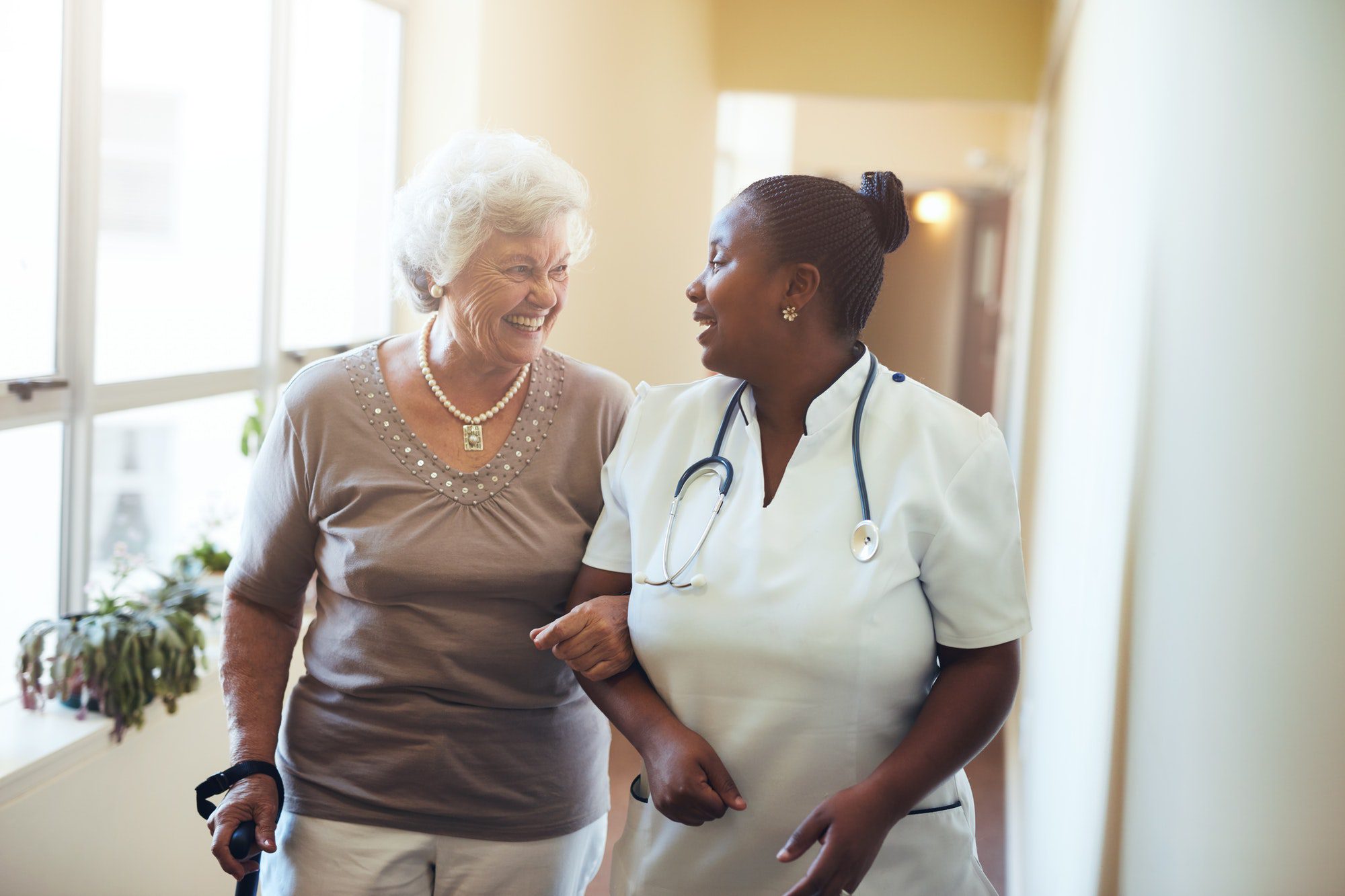 Nurse assisting senior woman at nursing home with a Medicare Advantage Special Needs Plan.