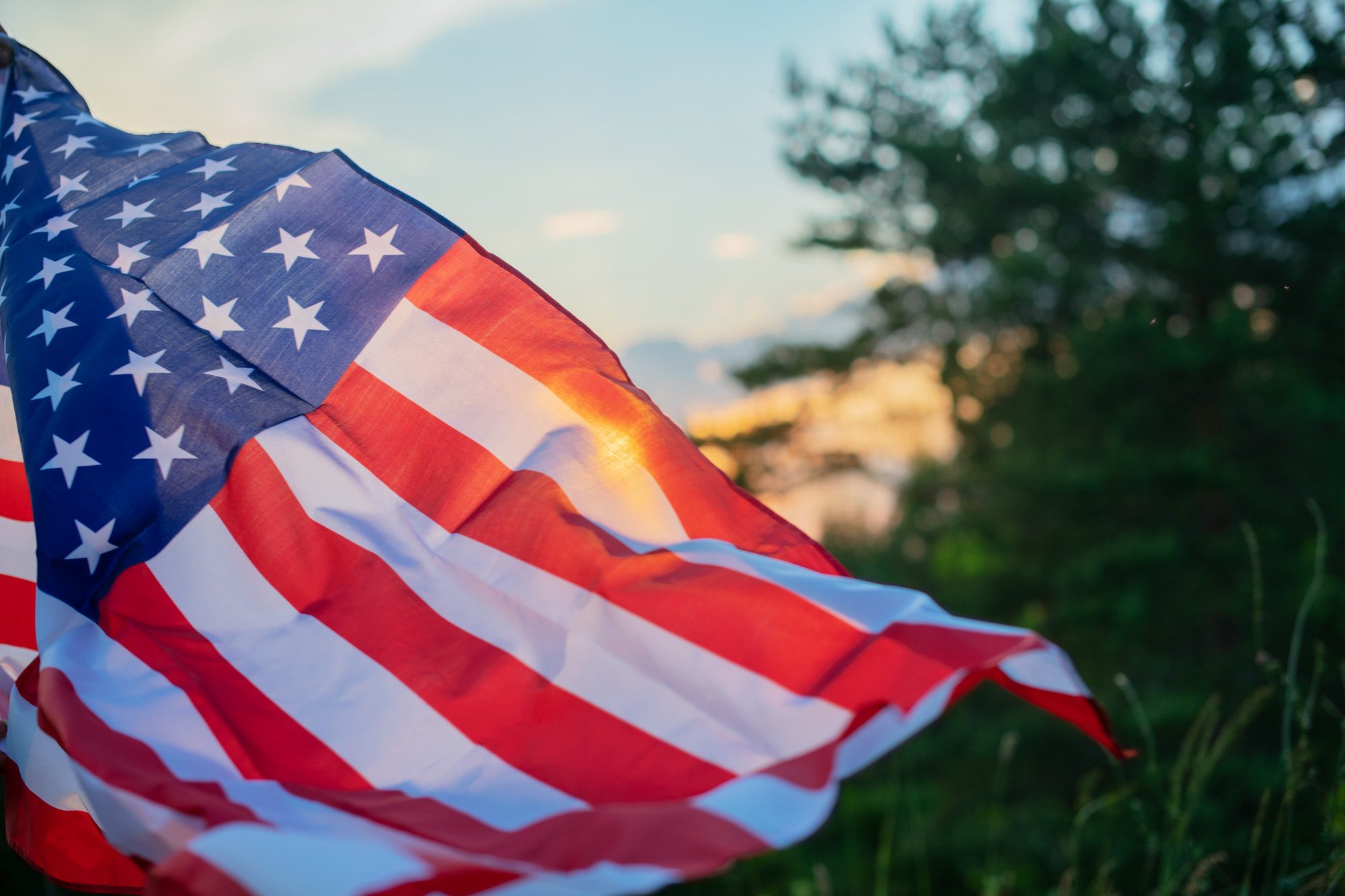 American flag waving in the wind representing the VA (Veterans of America).