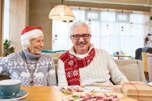 Happy senior couple celebrating Christmas as they discuss their options in Medicare Part A, B, C, and D