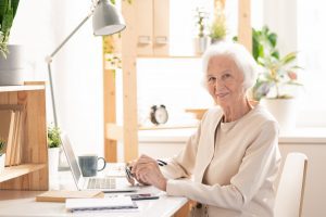 Senior woman writing blog posts about Medicare Advantage versus Medigap plans.